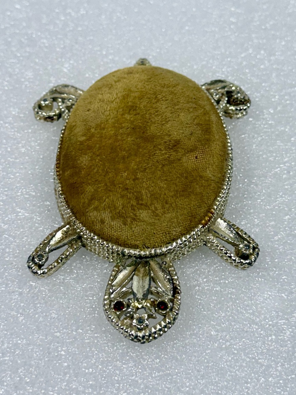 Vintage gold-tone metal turtle pin cushion featuring a textured body